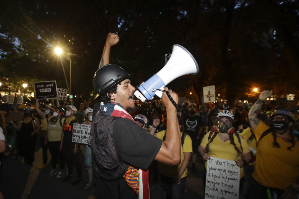 A demonstrator leads a chant during a Black Lives Matter protest at the Mark O. Hatfield United States Courthouse Wednesday, July 29, 2020, in Portland, Ore. (AP Photo/Marcio Jose Sanchez)