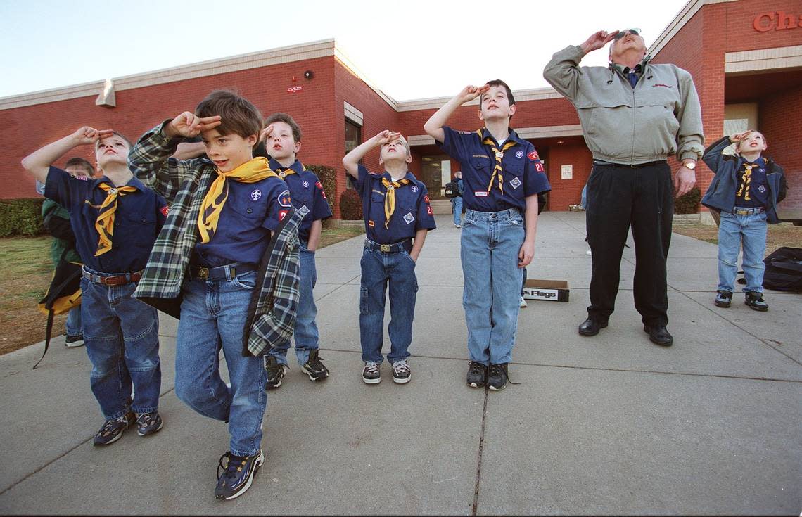 Feb. 8, 2000: Cub Scouts at Charlotte Anderson Elementary in Arlington salute as the flag is raised on the 90th anniversary of Scouting in the USA. From left, Chance Watkins, Andrew Haslam, Patrick Hayes, Tyler Temple, Steven Sutton, David Hayes and Danny Clark. Paul Moseley/STAR TELEGRAM