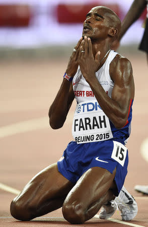 Mo Farah of Britain reacts after winning the men's 5000 metres final at the 15th IAAF Championships at the National Stadium in Beijing, China August 29, 2015. REUTERS/Dylan Martinez