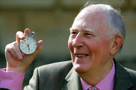 FILE PHOTO: Sir Roger Bannister, who ran the first sub-four-minute mile in 1954, holds the stop watch used by Harold Abrahams to time the race during 50th anniversary celebrations at Pembroke College, Oxford, May 6, 2004. REUTERS/David Bebber/File Photo