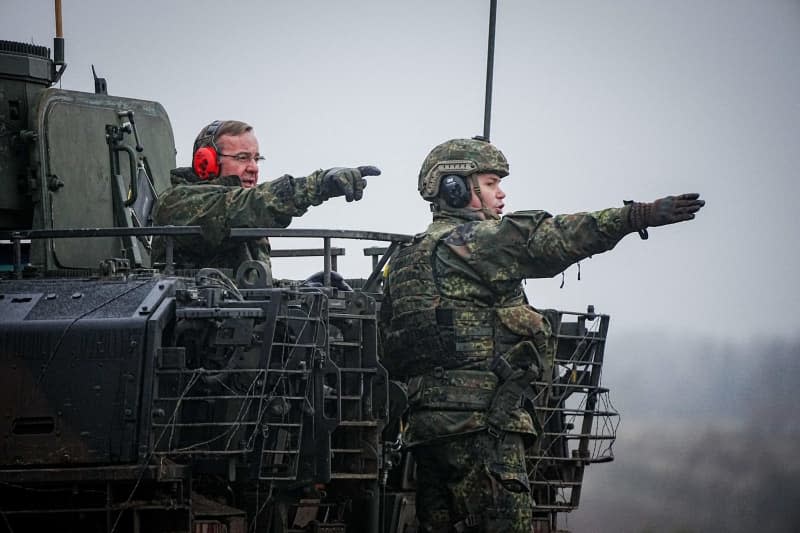Boris Pistorius (L), German Minister of Defence stands with a soldier in a Puma infantry fighting vehicle during his inaugural visit to the Bundeswehr at the Altengrabow military training area. For the first time in three decades, Germany has notified NATO of planned defence spending amounting to at least 2% GDP. Kay Nietfeld/dpa