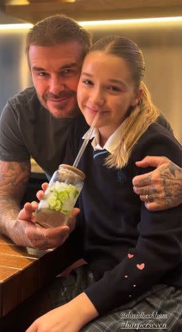 <p>Victoria Beckham Instagram</p> David Beckham and Harper smiling after he made her cucumber water on Nov.22, 2023