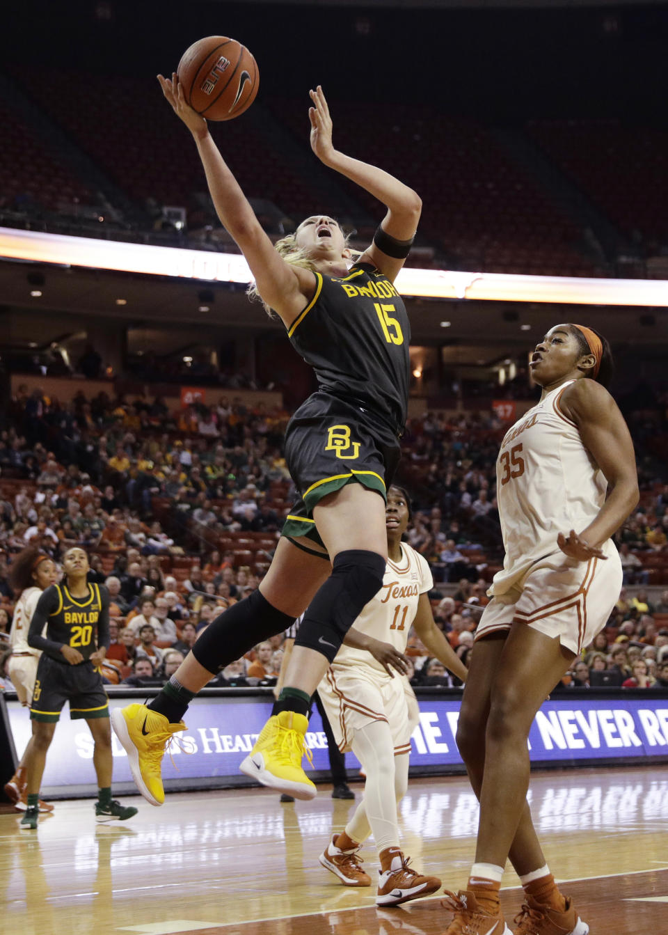 Baylor forward Lauren Cox (15) drives past Texas forward Charli Collier (35) during the first half of an NCAA college basketball game Friday, Jan. 31, 2020, in Austin, Texas. (AP Photo/Eric Gay)