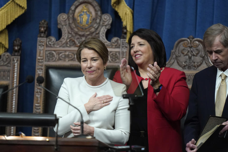 Massachusetts Gov. Maura Healey, left, acknowledges applause after being sworn into office as Kim Driscoll, center, and Mass. Secretary of the Commonwealth William Galvin, right, stand nearby on the rostrum in the House Chamber at the Statehouse during inauguration ceremonies, Thursday, Jan. 5, 2023, in Boston. (AP Photo/Steven Senne)