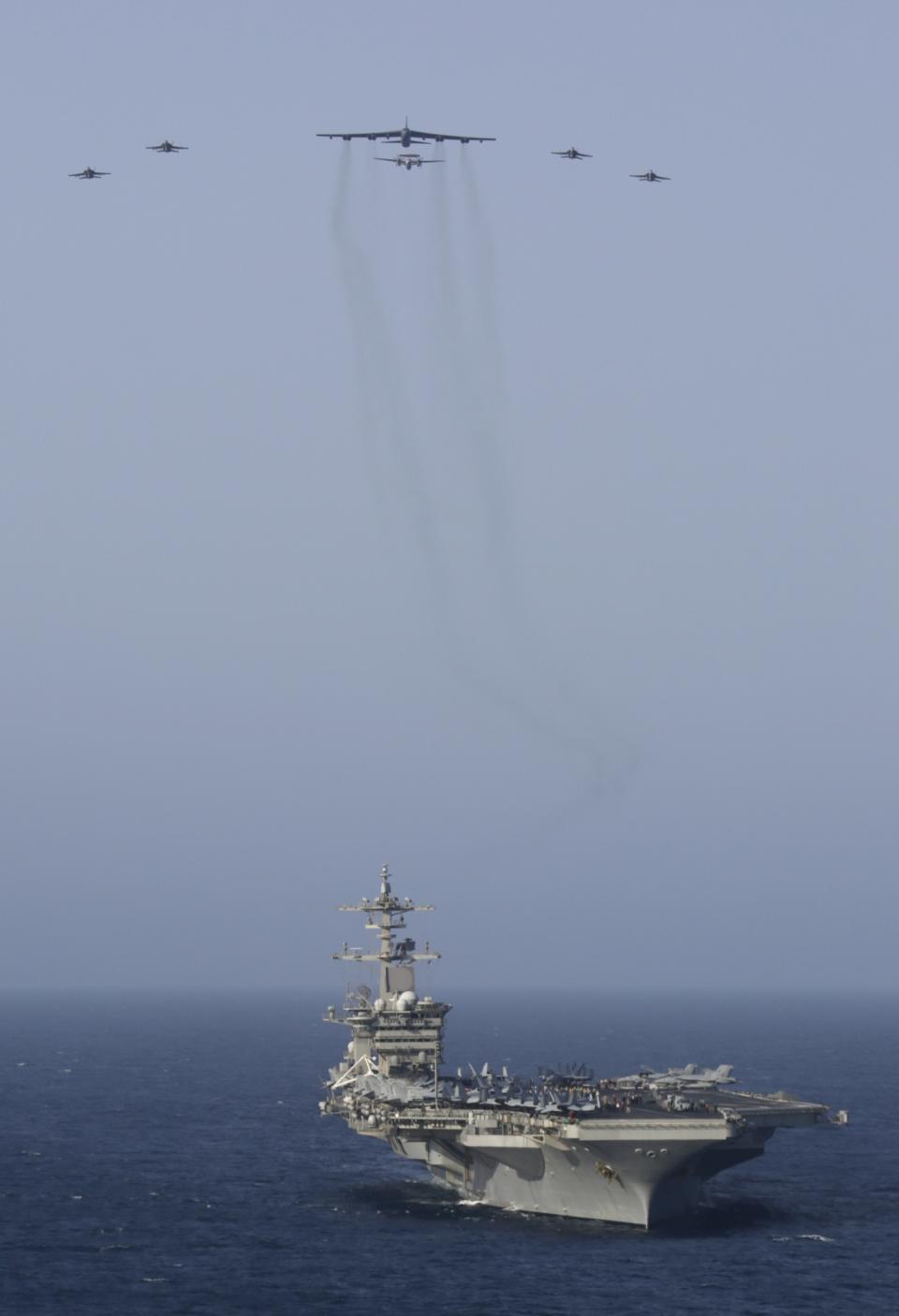 In this Saturday, June 1, 2019 photo, Abraham Lincoln Carrier Strike Group and a U.S. Air Force B-52H Stratofortress, assigned to the 20th Expeditionary Bomb Squadron and part of the Bomber Task Force deployed to the region, conduct joint exercises in the U.S. Central Command area of responsibility in Arabian sea. (Mass Communication Specialist 1st Class Brian M. Wilbur/U.S. Navy via AP)
