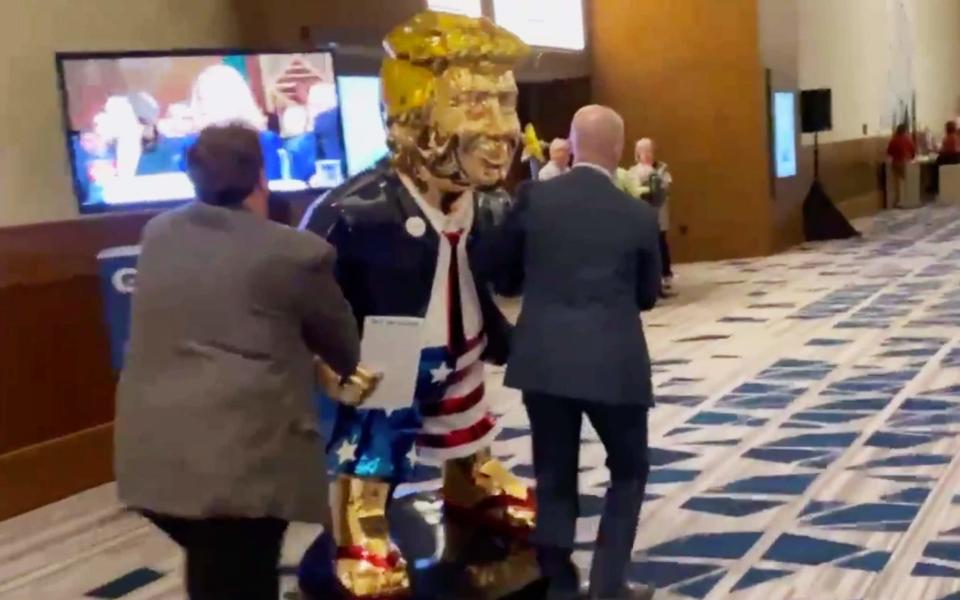 A gold statue of Trump at CPAC - Twitter