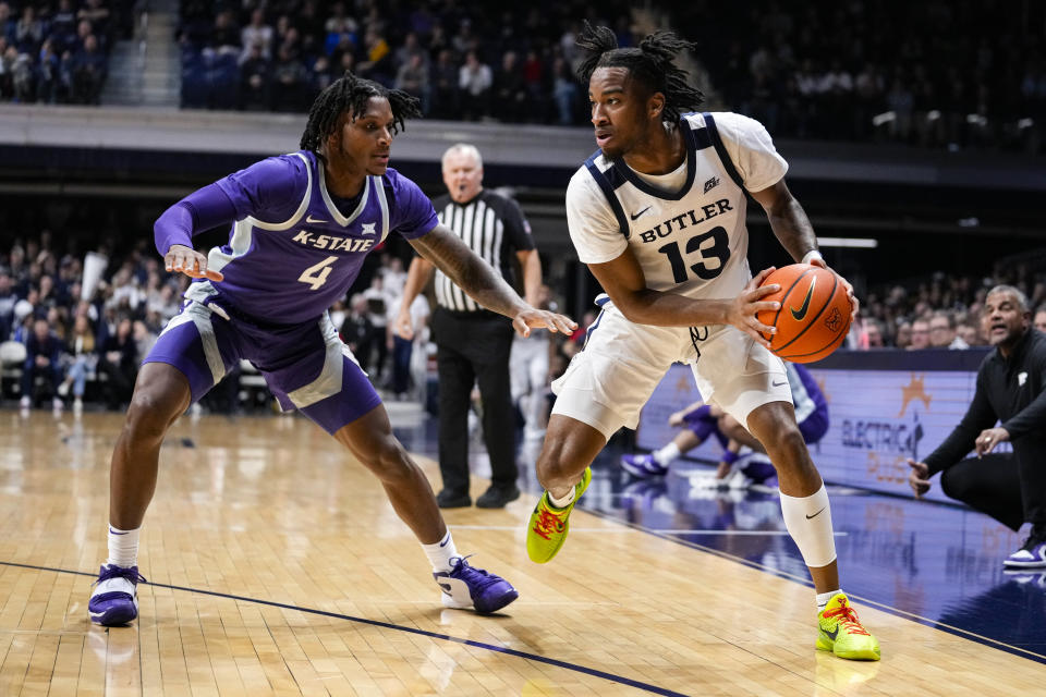 Butler guard Jayden Taylor (13) drives on Kansas State guard Tykei Greene (4) in the first half of an NCAA college basketball game in Indianapolis, Wednesday, Nov. 30, 2022. (AP Photo/Michael Conroy)