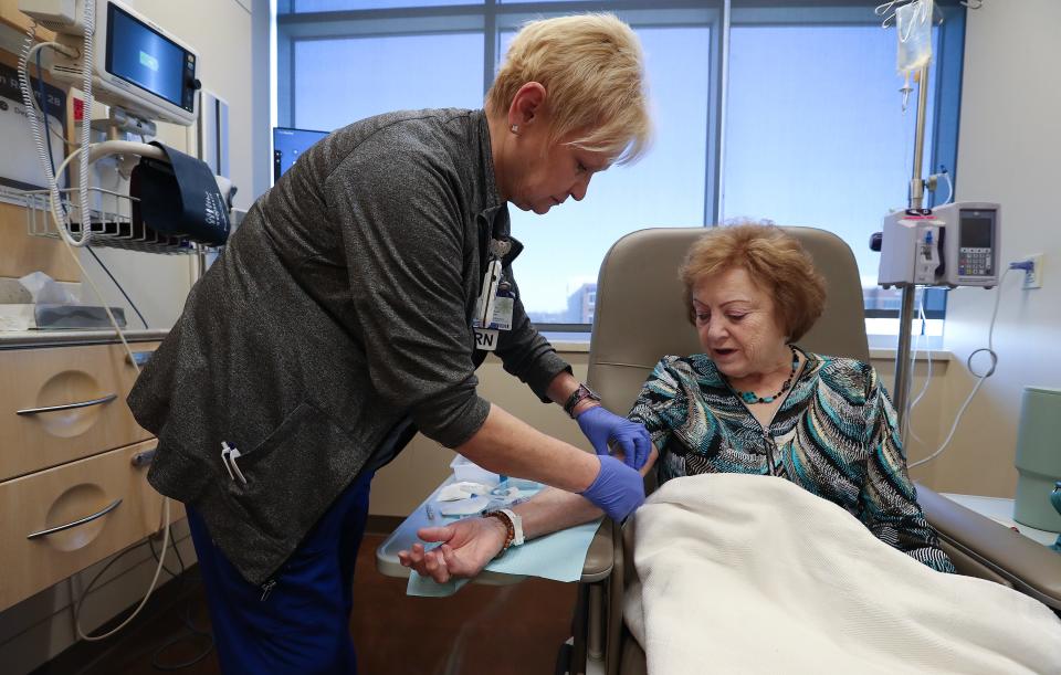 Registered nurse Jo Richardson, left, preps Bobbie West before she receives her 12th infusion treatment for Alzheimer's at the Norton Cancer Institute in Louisville, Ky. on Feb. 20, 2024.