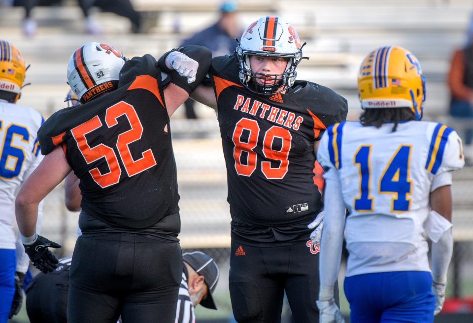 Washington's Carter Prina (89) and Noah Bell-Lorentzen lock arms in celebration of a sack during a playoff game last season. The duo returns in 2024 to lead the Panthers defense.