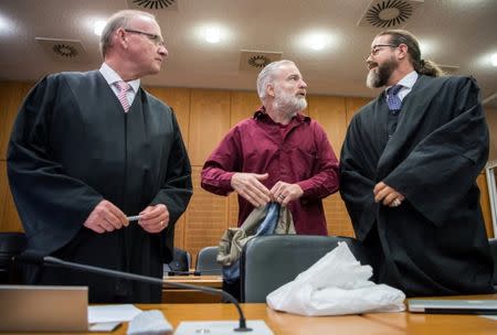 Defendant Swiss man Daniel M., accused of spying on a German tax authority to find out how it obtained details of secret Swiss bank accounts set up by Germans to avoid tax, stands next to his lawyers Hannes Linke (L) and Anwalt Robert Kain (R) before the start of his trial on espionage charges, in the Higher Regional Court in Frankfurt am Main, Germany October 18, 2017. REUTERS Andreas Arnold/Pool