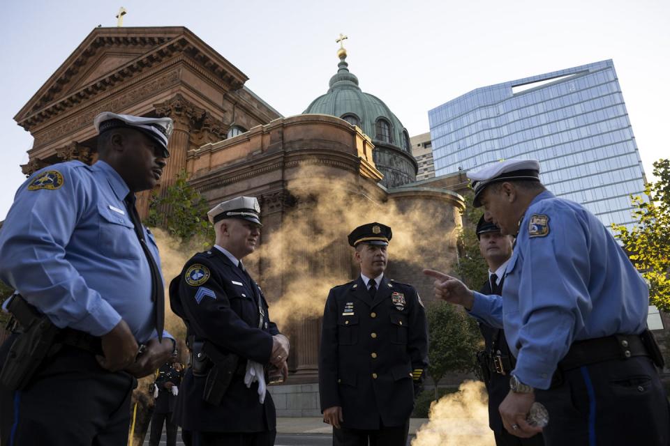 Philadelphia law enforcement officers stand together in front of church in downtown Philadelphia