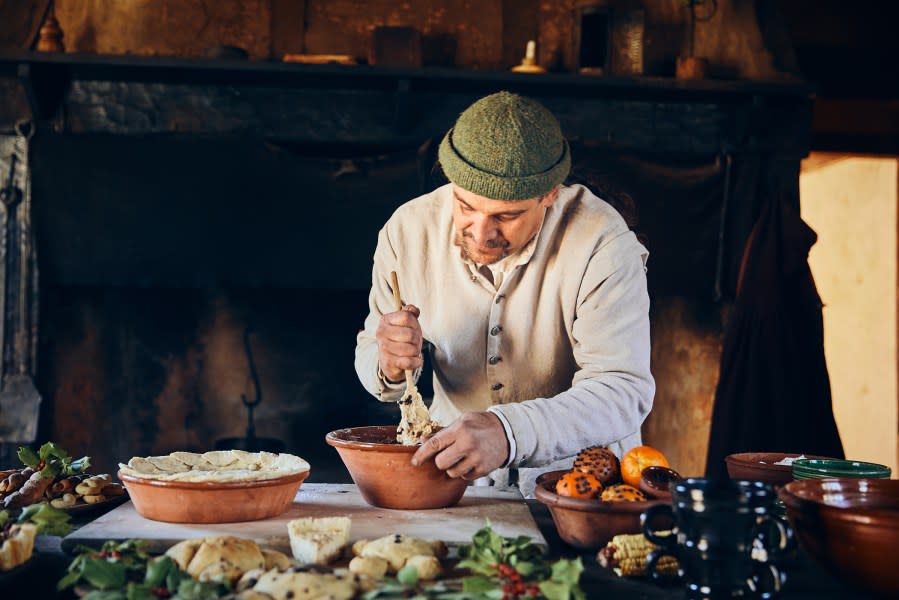 In Jamestown Settlement’s re-created fort, a historical interpreter mixes ingredients for period recipes prepared over an open hearth. Image courtesy of Visit Williamsburg.