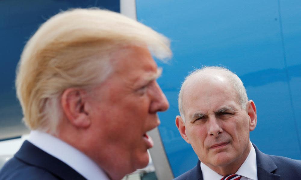 John Kelly watches as Donald Trump talks to the medi, in Maryland in May.