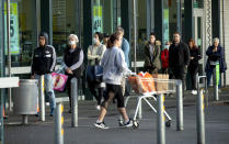 People queue early morning outside a supermarket in Hobsonville, Auckland as New Zealand prepares to move into Covid-19 Alert Level 3, Wednesday, Aug. 12, 2020. New Zealand Prime Minister Jacinda Ardern said Tuesday, Aug. 11 authorities have found four cases of the coronavirus in one Auckland household from an unknown source, the first reported cases of local transmission in the country in 102 days. (Dean Purcell/New Zealand Herald via AP)