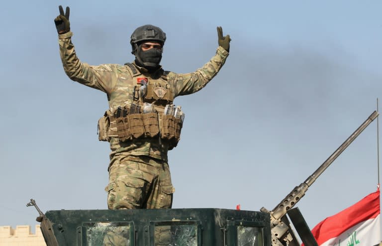 A pro-government forces fighter flashes the victory sign near al-Sejar village, north-east of Fallujah