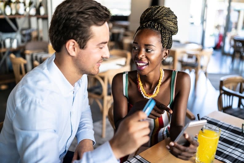 Couple has card out to pay in a restaurant.