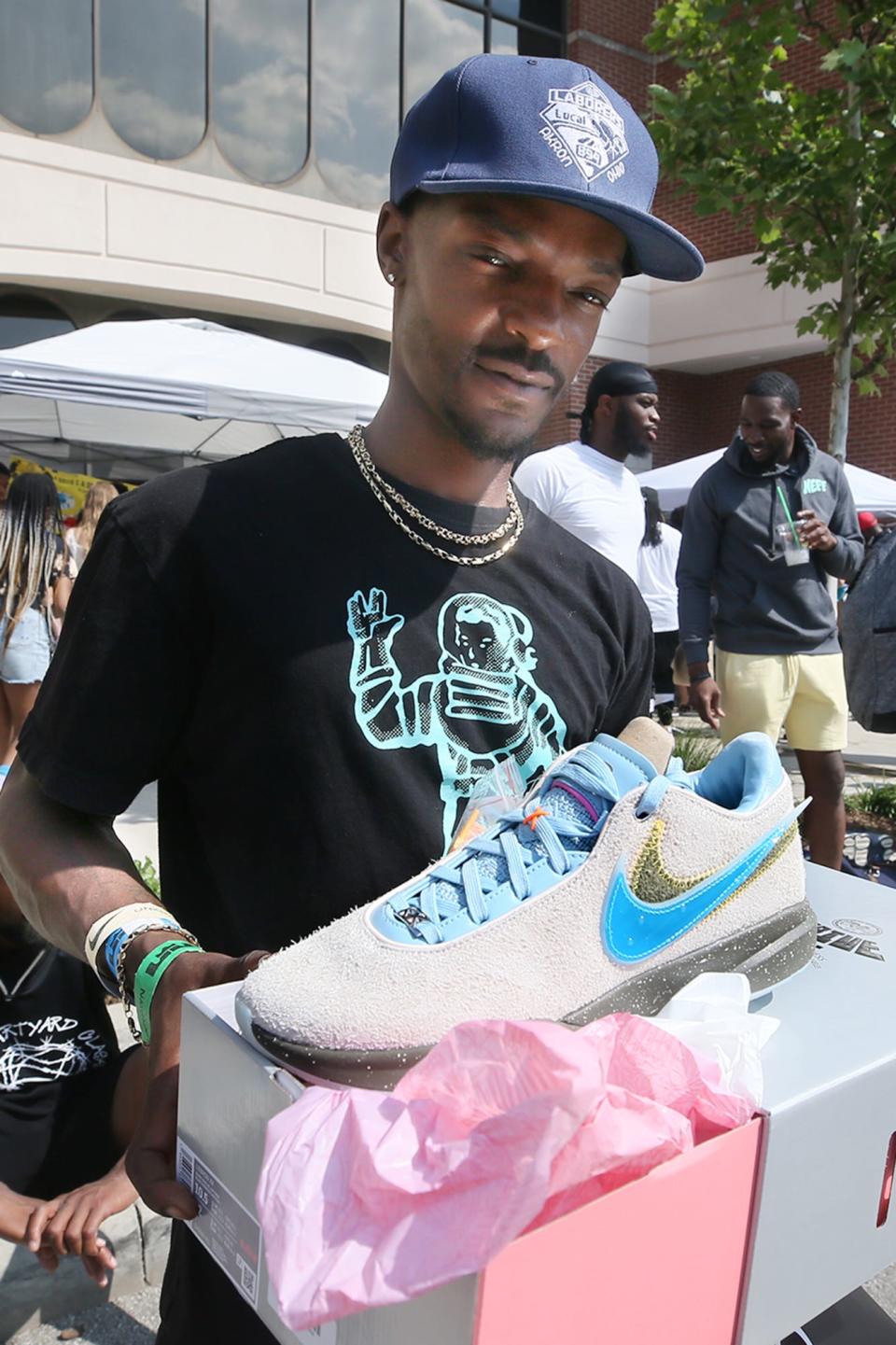 Renaldo Tyson shows the limited edition UNKNWN x Nike LeBron XX "Message In A Bottle" sneaker collaboration outside of the UNKNWN Akron store on Main Street.
