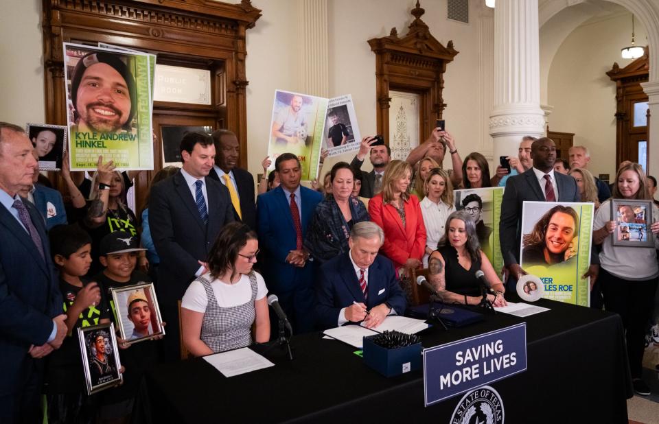 Gov. Greg Abbott signs one of four bills aimed at curbing the growing fentanyl crisis during the Fighting the Fentanyl Crisis Bill signing at the Texas Capitol on June 14. The laws designate October as Fentanyl Poisoning Awareness Month, require schools to provide education on fentanyl abuse prevention and make it clear that people who cause death by distributing fentanyl can be prosecuted for murder.