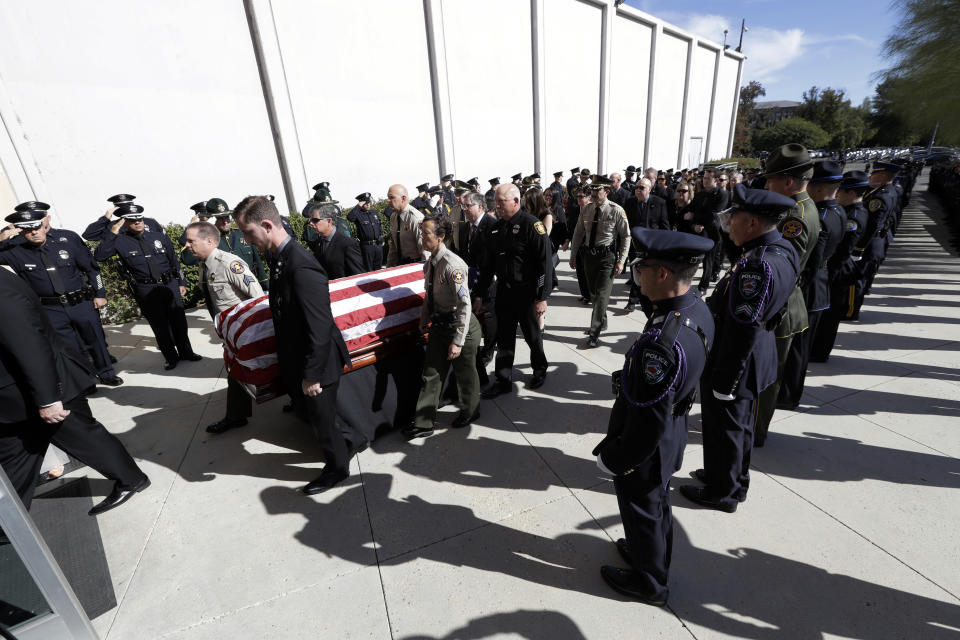 A casket carrying the body of Ventura County Sheriff's Sgt. Ron Helus arrives at the Calvary Community Church Thursday, Nov. 15, 2018, in Westlake Village, Calif. Helus was fatally shot while responding to a mass shooting at a country music bar in Southern California. (AP Photo/Marcio Jose Sanchez, Pool)