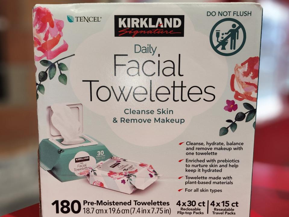 Box of Kirkland-brand facial towelettes on a red table