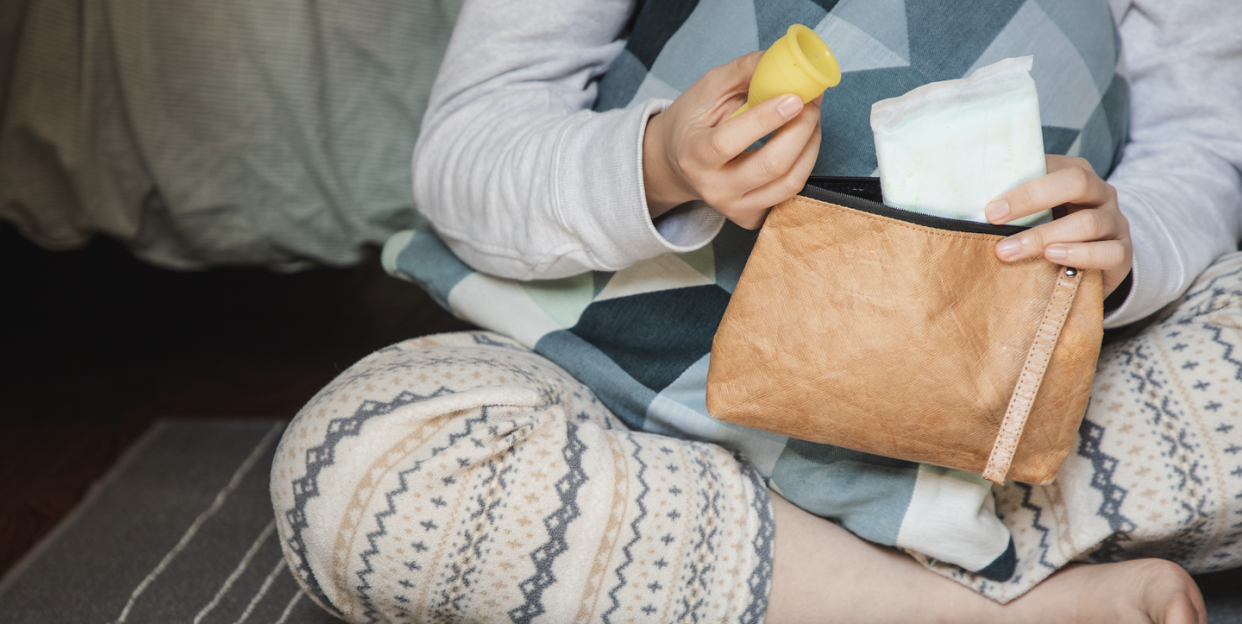 woman looks at sanitary products