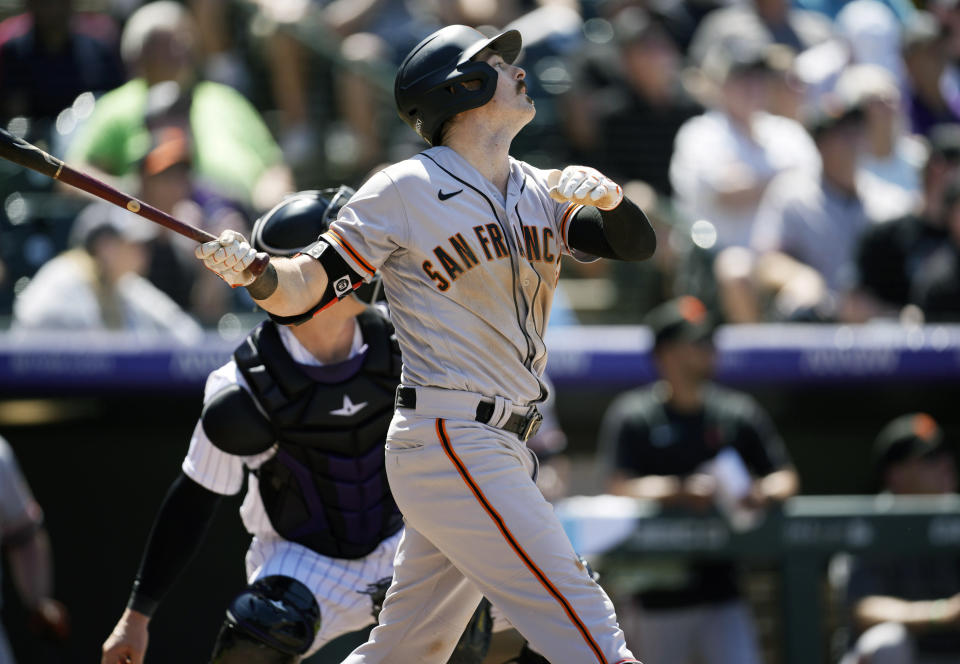 San Francisco Giants' Mike Yastrzemski flies out against Colorado Rockies starting pitcher Kyle Freeland in the sixth inning of a baseball game Wednesday, May 18, 2022, in Denver. (AP Photo/David Zalubowski)