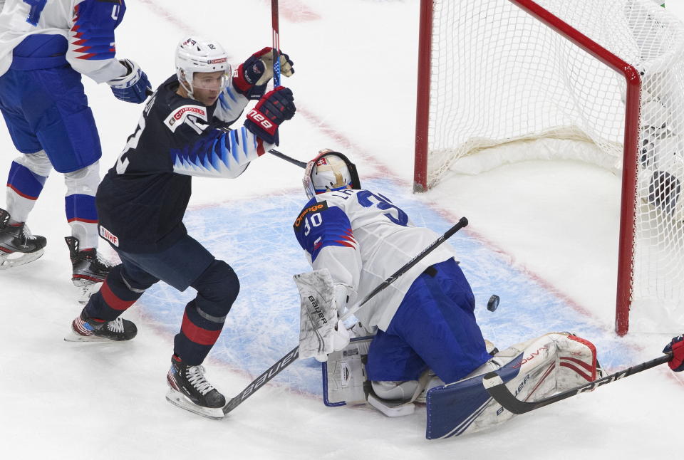 United States' Matthew Boldy (12) reacts as the puck go in past Slovakia goalie Simon Latkoczy (30) during the second period of an IIHL World Junior Hockey Championship game, Saturday, Jan. 2, 2021 in Edmonton, Alberta. (Jason Franson/The Canadian Press via AP)