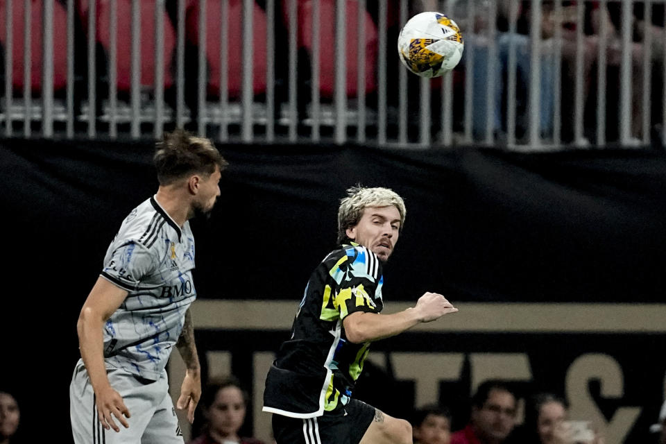 CF Montréal midfielder Ilias Iliadis (5) and Atlanta United midfielder Saba Lobjanidze (9) vie for a kicked ball during the first half of a MLS soccer match, Saturday, Sept. 23, 2023, in Atlanta. (AP Photo/Mike Stewart)