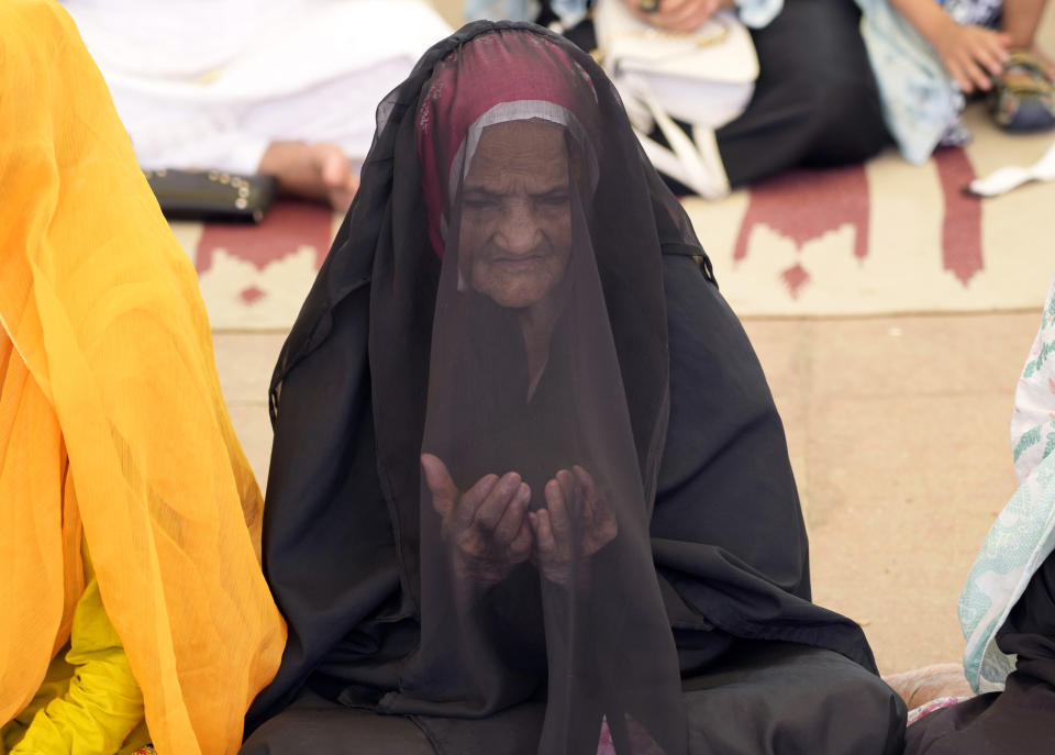 A woman attends Eid al-Adha prayers at historical Badshahi mosque in Lahore, Pakistan, Monday, June 17, 2024. Eid al-Adha or Feast of Sacrifice, the most important Islamic holiday, marks the willingness of the Prophet Ibrahim, Abraham to Christians and Jews, to sacrifice his son. During the holiday, which in most places lasts three days, Muslims slaughter goat, sheep or cattle, distribute part of the meat to the poor. (AP Photo/K.M. Chaudary)