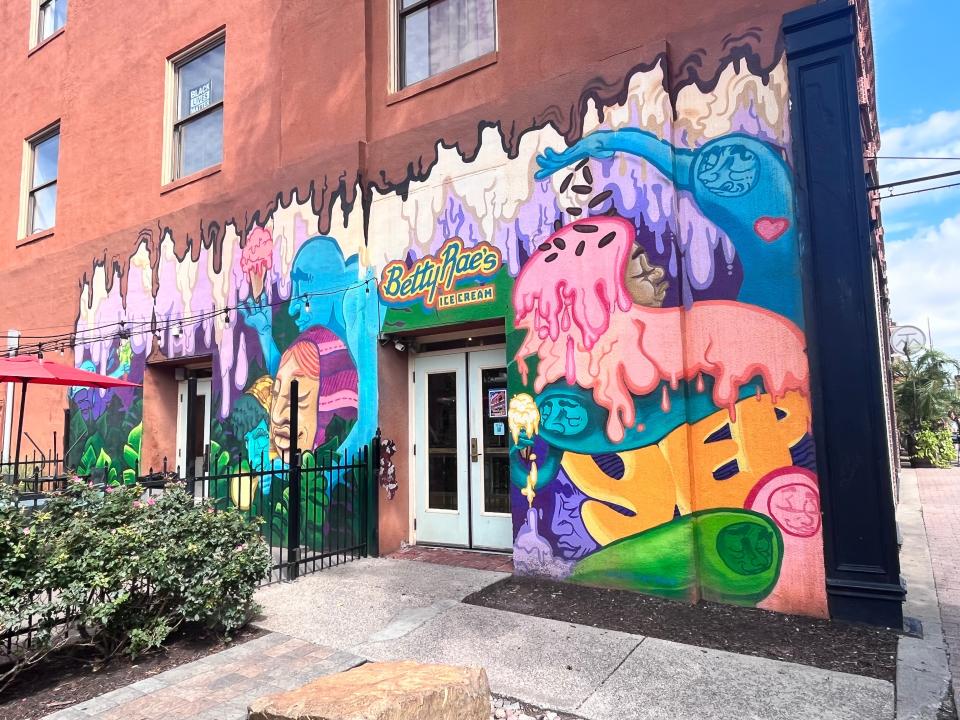 colorful mural on the side of a brick building in kansas city