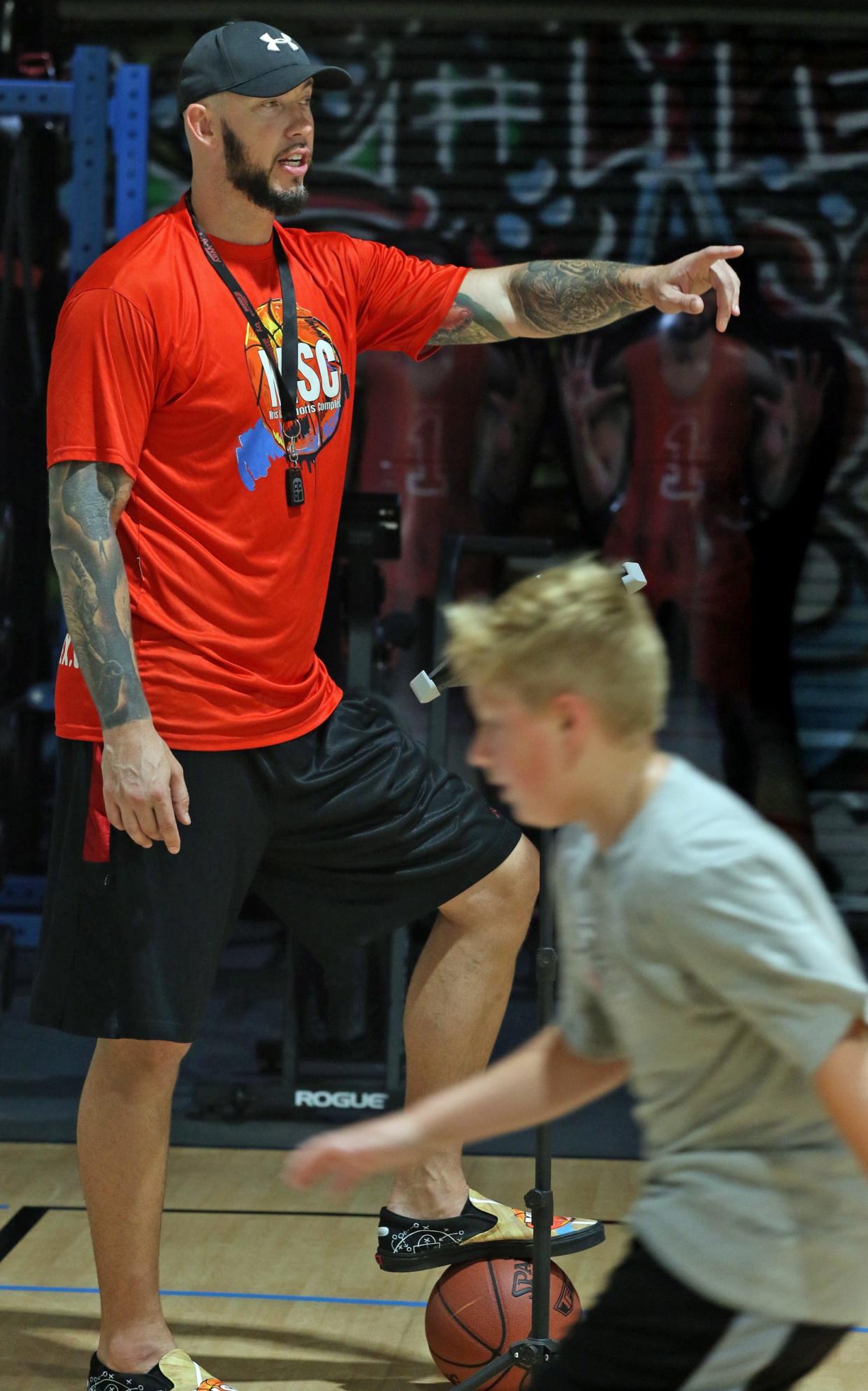 Former Hunter Huss and Tar Heel standout Kris Lang works with kids in this August 2022 Gazette file photograph at his Kris Lang Sport Complex in Belmont. On Saturday, Oct. 1, 2022, the gym will hold an NBA styled skills contest and community event.