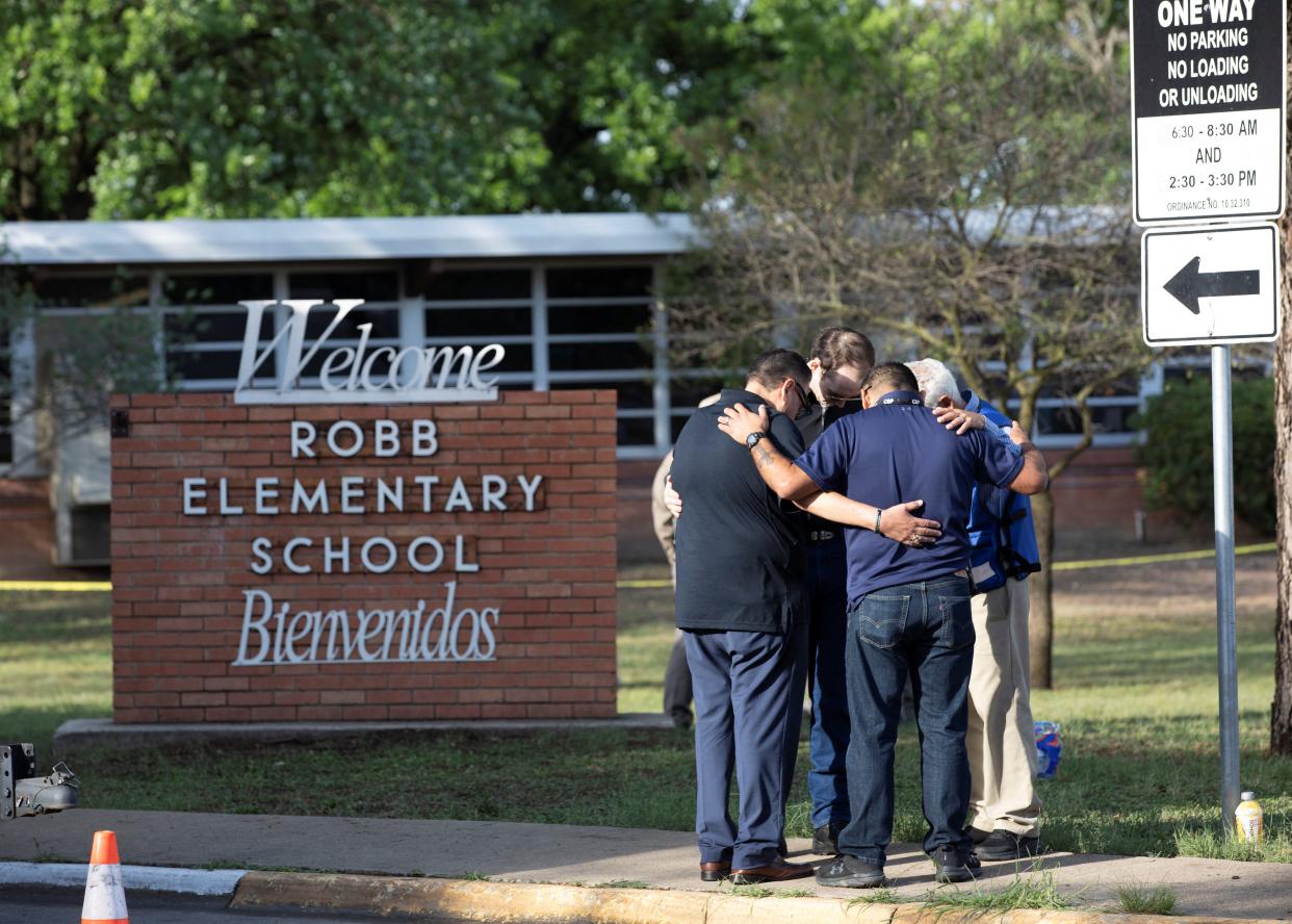 People gather at Robb Elementary School, the scene of a mass shooting in Uvalde, Texas, U.S. May 25, 2022.