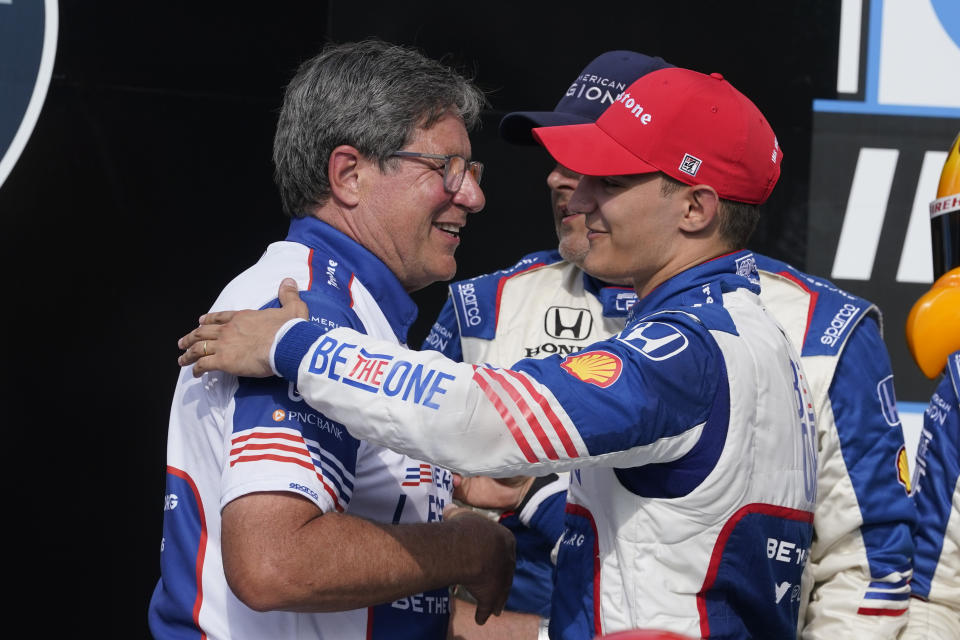 Alex Palou, right, of Spain, celebrates with a crew member after winning the IndyCar Grand Prix auto race at Indianapolis Motor Speedway, Saturday, May 13, 2023, in Indianapolis. (AP Photo/Darron Cummings)