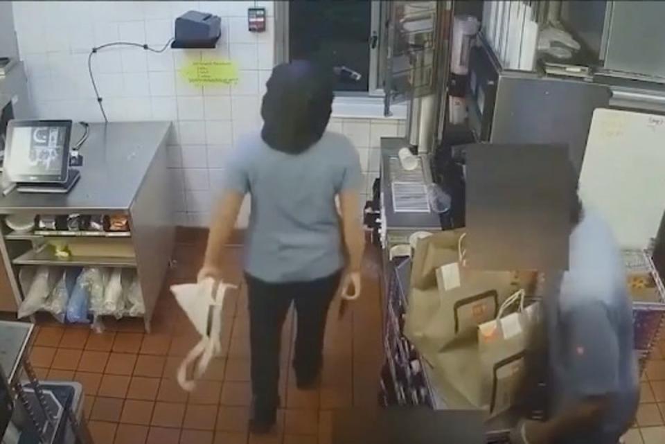 A McDonald’s employee is seen with a gun before shooting at a drive-thru customer (Lakeland police)