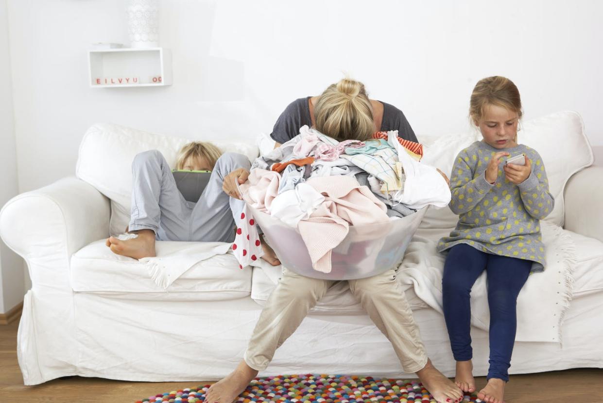 <span class="caption">Many families have had a hard time since schools and day care centers had to shut their doors.</span> <span class="attribution"><a class="link " href="https://www.gettyimages.com/detail/photo/exhausted-mother-with-laundry-basket-on-couch-with-royalty-free-image/548004361" rel="nofollow noopener" target="_blank" data-ylk="slk:Westend61/Getty Images;elm:context_link;itc:0;sec:content-canvas">Westend61/Getty Images</a></span>
