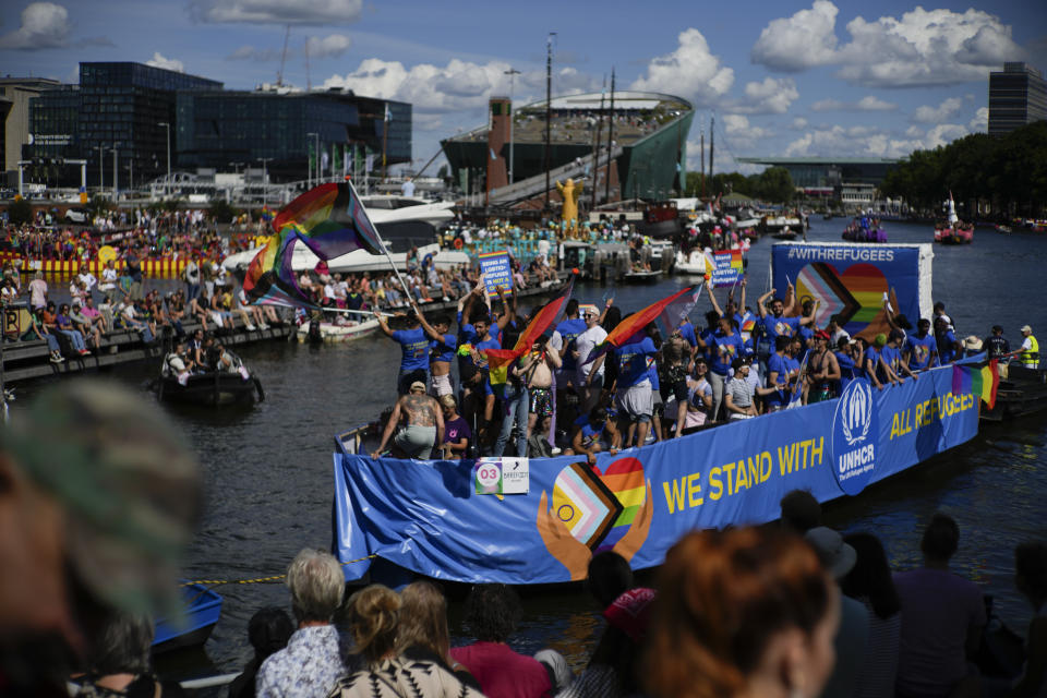 Thousands of people lined canals in the Dutch capital to watch the colorful spectacle of the Pride Canal Parade return for the 25th edition after the last two events were canceled due to the COVID-19 pandemic, in Amsterdam, Netherlands, Saturday, Aug. 6, 2022. (AP Photo/Peter Dejong)