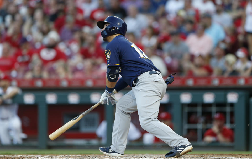 Milwaukee Brewers' Keston Hiura (18) watches the flight of a solo home run off Cincinnati Reds starting pitcher Tyler Mahle during the fifth inning of a baseball game, Monday, July 1, 2019, in Cincinnati. (AP Photo/Gary Landers)