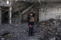 A federal police officer stands inside a damaged house after it was hit by an air strike, in Hamam al-Alil, Iraq, Sunday, Feb. 19, 2017. U.S.-backed Iraqi forces launched a large-scale military operation on Sunday to dislodge Islamic State militants from the western half of Mosul city. (AP Photo/Bram Janssen)