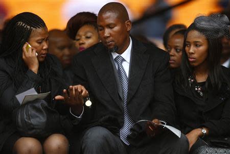 Mandla Mandela (C), eldest grandson of former South African President Nelson Mandela, attends the official memorial service for Nelson Mandela at the First National Bank stadium, also known as Soccer City, in Johannesburg December 10, 2013. REUTERS/Kai Pfaffenbach