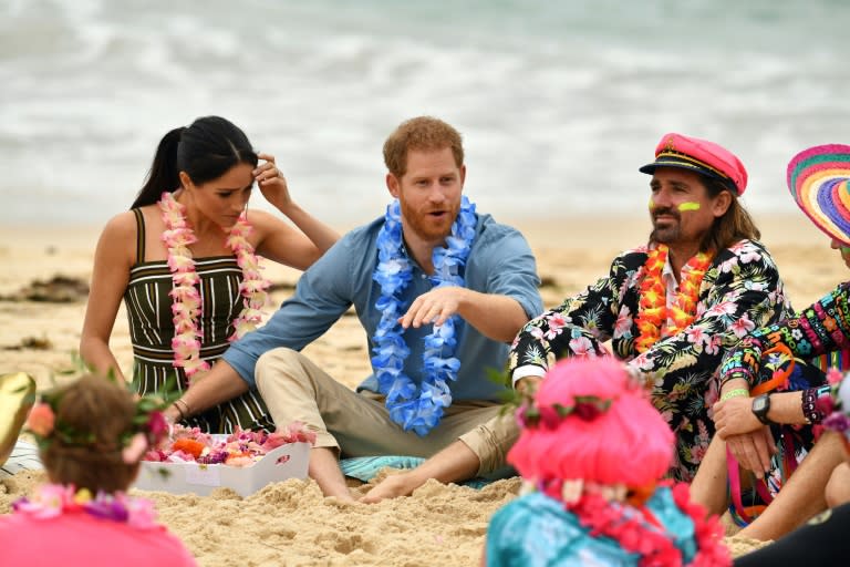 Britain's Prince Harry and his wife Meghan, Duchess of Sussex talk to members of OneWave, an awareness group for mental health and wellbeing at Sydney's Bondi Beach