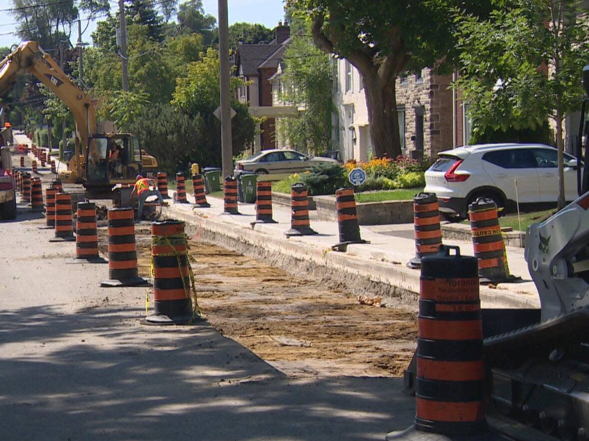 Some residents on Glen Cedar Road can't get their vehicles in or out of their driveways while construction resumes. (Paul Smith/CBC - image credit)