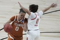 Texas's Celeste Taylor tries to get past Maryland's Katie Benzan during the second half of an NCAA college basketball game in the Sweet 16 round of the Women's NCAA tournament Sunday, March 28, 2021, at the Alamodome in San Antonio. (AP Photo/Morry Gash)