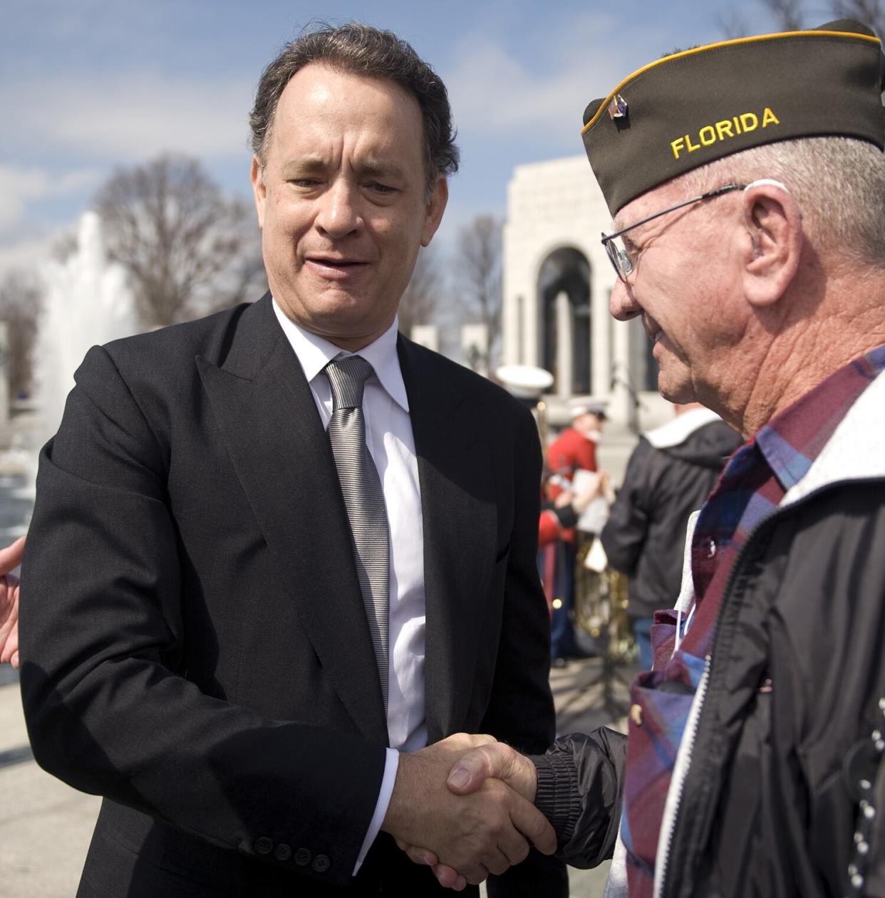 Tom Hanks, greets a World War II veteran after a tribute to honor WW II vets that served in the Pacific Theater