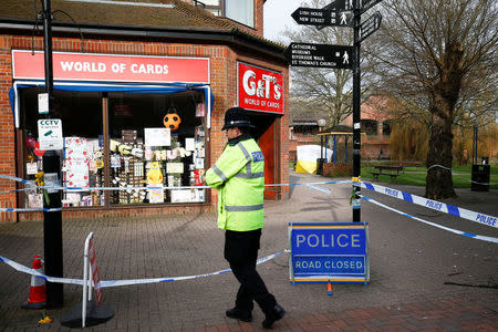 A police officer stands at a cordon around the bench where former Russian intelligence agent Sergei Skripal and his daughter Yulia were found after they were poisoned, in Salisbury, Britain March 14, 2018. REUTERS/Henry Nicholls/Files