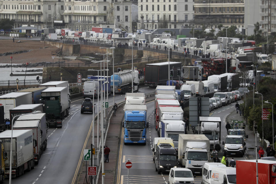 Trucks parked on the roadside whilst the Port remains closed, in Dover, southern England, Tuesday, Dec. 22, 2020. Trucks waiting to get out of Britain backed up for miles and people were left stranded at airports as dozens of countries around the world slapped tough travel restrictions on the U.K. because of a new and seemingly more contagious strain of the coronavirus in England. (AP Photo/Kirsty Wigglesworth)