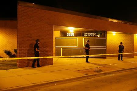 Police stand guard after disturbances following the police shooting of a man in Milwaukee, Wisconsin, U.S. August 14, 2016. REUTERS/Aaron P. Bernstein