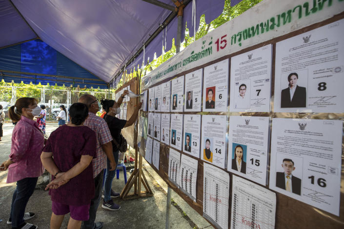 Voters check candidates information at a polling station in Bangkok, Thailand, Sunday, May 14, 2023. Voters in Thailand were heading to the polls on Sunday in an election touted as a pivotal chance for change, eight years after incumbent Prime Minister Prayuth Chan-ocha first came to power in a 2014 coup. (AP Photo/Wason Wanichakorn)