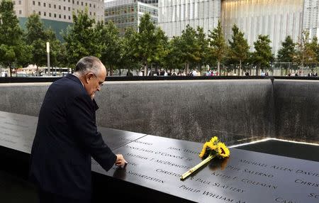 Former New York City Mayor Rudolph Giuliani stands at the edge of the North Pool during memorial observances held at the site of the World Trade Center in New York, September 11, 2014. REUTERS/Justin Lane/Pool