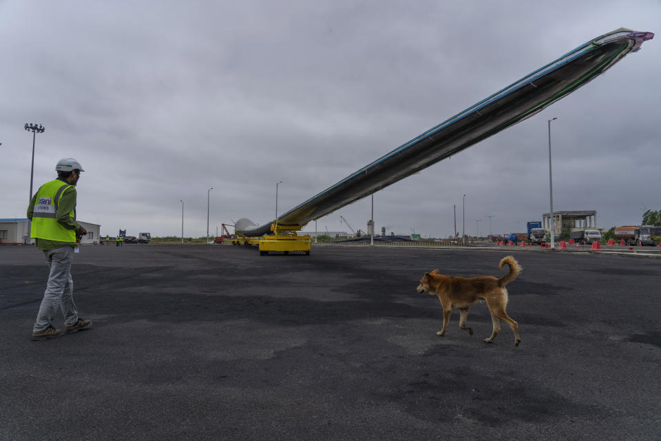 An employee works to transport a wind turbine blade for painting at the Adani New Industries Limited, one of India's largest solar panels and wafers manufacturing facility in the port town of Mundra in Western India's Gujarat state, India, Wednesday, Sept. 20, 2023. It's one of the few locations in India where most solar energy components are made from scratch. (AP Photo/Rafiq Maqbool)