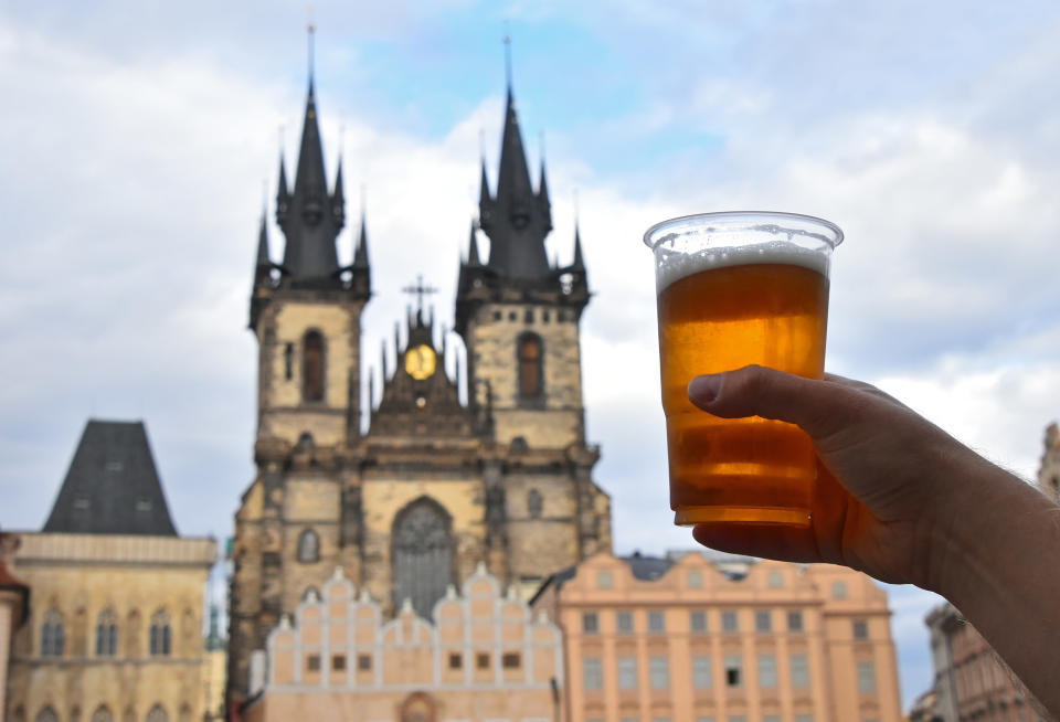 Someone holding a beer in Prague.